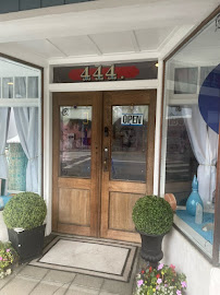 Wooden double doors at 444 Petaluma Boulevard North with an open sign and potted topiaries